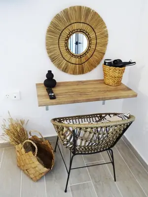 a mirror on a shelf next to a basket at Callas Residence in Triánta