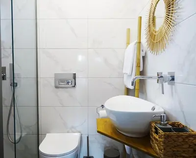 a bathroom with a sink and a toilet at Callas Residence in Triánta