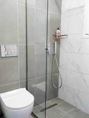 a bathroom with a shower and a toilet at Callas Residence in Triánta