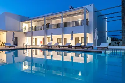 a swimming pool in front of a building at Kellys Luxury Apartments in Faliraki