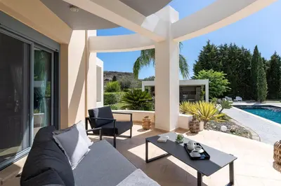 a living room with a couch and a table at Villa Rapha Maris in Afantou