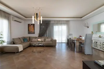 a living room with a couch and a table at Villa Rapha Maris in Afantou