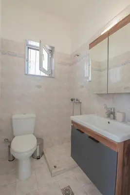 a bathroom with a toilet and a sink at The Green Beauty in Pastida