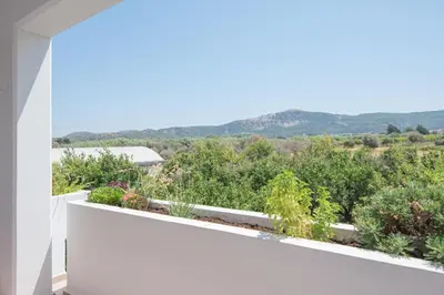 a view from the balcony of a house with plants at The Green Beauty in Pastida