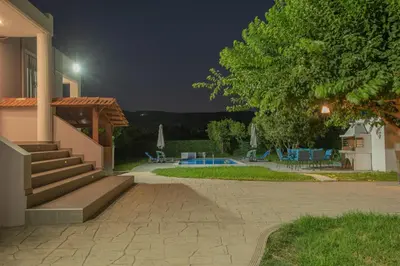 a house with stairs and a pool at night at The Green Beauty in Pastida