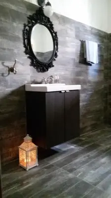 a bathroom with a sink and a mirror on the wall at Emmanuel Apartments in Rhodes Town