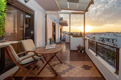 a balcony with a table and chairs and a view at Loft style apartment near the Old Town in Rhodes Town
