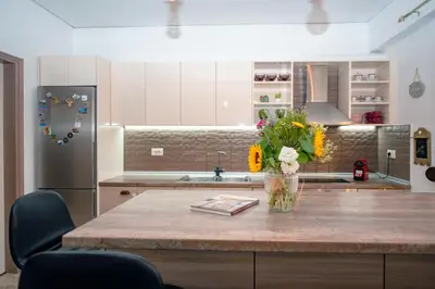 a kitchen with a table with a vase of flowers on it at Loft style apartment near the Old Town in Rhodes Town