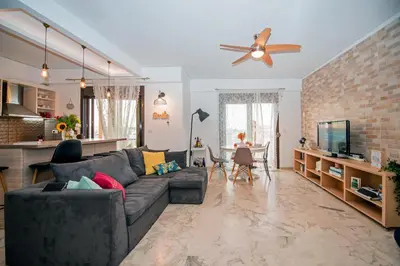 a living room with a couch and a dining room at Loft style apartment near the Old Town in Rhodes Town