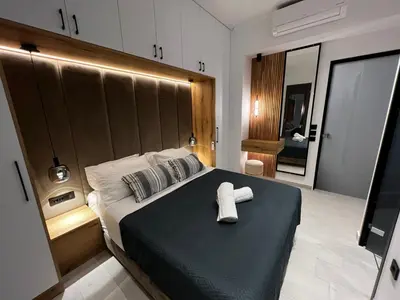 a bedroom with a bed with a towel on it at City Compass Luxury Suites in Rhodes Town