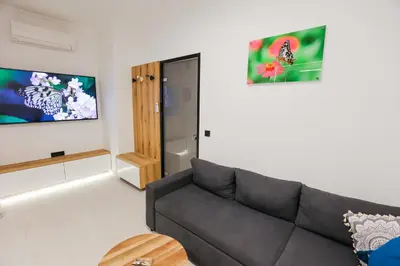 a living room with a couch and a door at City Compass Luxury Suites in Rhodes Town