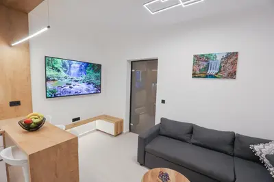 a living room with a couch and a table at City Compass Luxury Suites in Rhodes Town