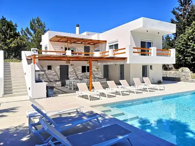 a villa with a swimming pool and a house at Chrysanthi Villa, Living in Nature in vlicha