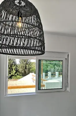 a light hanging over a window in a room at Chrysanthi Villa, Living in Nature in vlicha