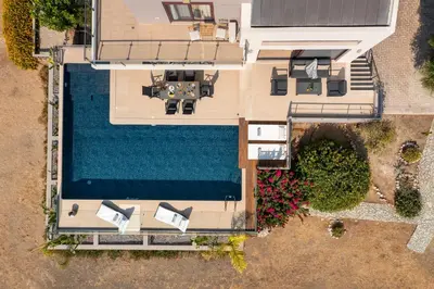 an overhead view of a pool with chairs and a house at Ethereum Villa in Asgourou