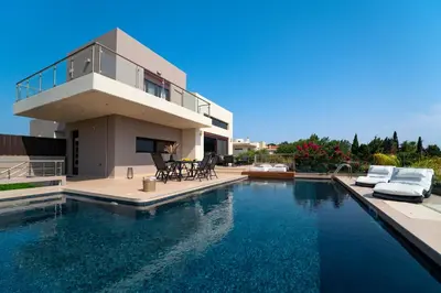 a house with a swimming pool in front of a house at Ethereum Villa in Asgourou