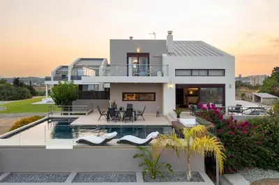 a villa with a swimming pool and a house at Ethereum Villa in Asgourou