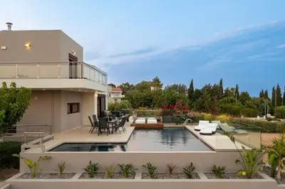 a house with a swimming pool in the backyard at Ethereum Villa in Asgourou