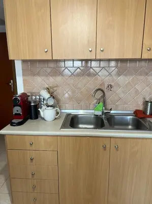 a kitchen with a sink and a counter top at Karakonero view apartment in Rhodes Town