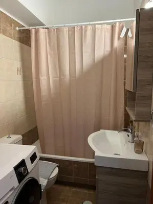 a bathroom with a sink and a shower curtain at Karakonero view apartment in Rhodes Town