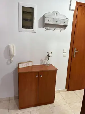 a room with a desk and a phone on a wall at Karakonero view apartment in Rhodes Town