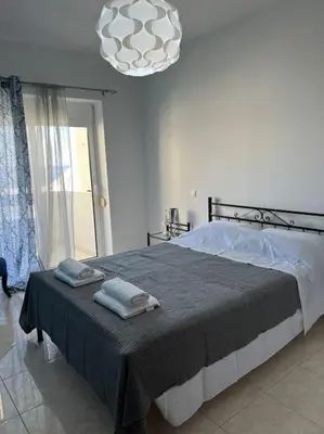 a bedroom with a bed with two towels on it at Karakonero view apartment in Rhodes Town