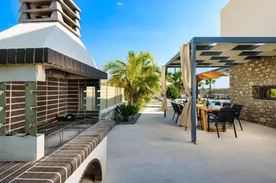 a patio with a table and chairs on a building at Lindian Palms in Lardos