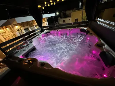 a purple bath tub with pink lights in it at Villa Massari in Haraki