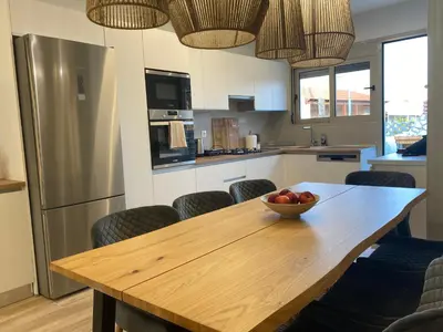 a kitchen with a wooden table with a bowl of fruit on it at Villa Massari in Haraki