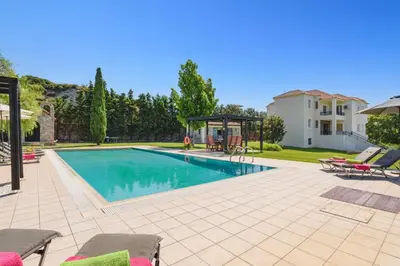 a swimming pool with a gazebo next to a house at Villa Amarandes With Private Pool in Paradeísion