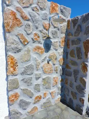 a stone wall with rocks on it at Onar Luxury Villa - Adults Only in Lachania