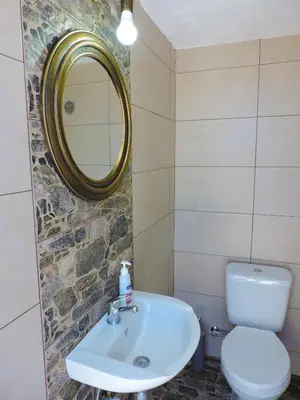 a bathroom with a sink and a toilet and a mirror at Onar Luxury Villa - Adults Only in Lachania