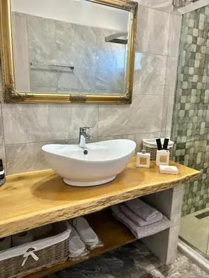a bathroom with a white sink and a mirror at Onar Luxury Villa - Adults Only in Lachania