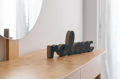 a wooden sign that says hello sitting on top of a table at Rhodes city studios in Rhodes Town