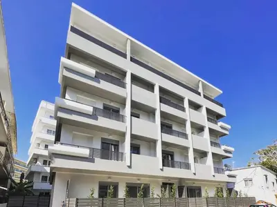 a white building with balconies and a blue sky at Rhodes city studios in Rhodes Town