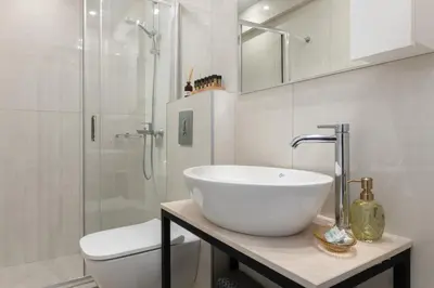 a white bathroom with a sink and a shower at Rhodes city studios in Rhodes Town
