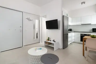 a living room with a kitchen and a table at Rhodes city studios in Rhodes Town