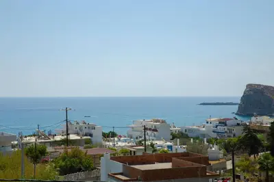 a view of a town with the ocean in the background at Ikia Seascape At Stegna in Archangelos