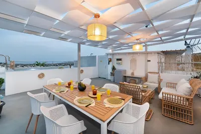 a dining room and living room with a table and chairs at Afandou Panorama Apartment in Afantou