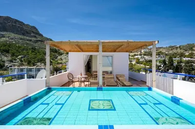 a swimming pool on the roof of a house at Stegna Sunrise Suite Sleeps 4 Pool in Archangelos