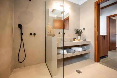 a bathroom with a shower with a glass door at CasaCarma III, private pool, boho design, central in Lachania