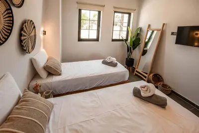 two beds in a room with hats on the floor at CasaCarma III, private pool, boho design, central in Lachania