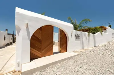 a building with a wooden door on a street at CasaCarma III, private pool, boho design, central in Lachania