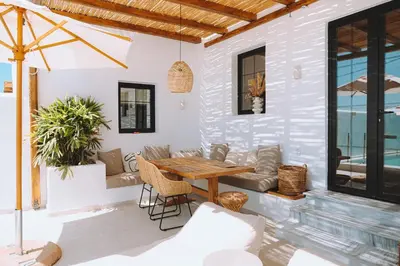 a patio with a wooden table and a couch at CasaCarma III, private pool, boho design, central in Lachania