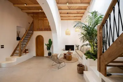 a living room with stairs and potted plants at CasaCarma II, private pool, boho design, tradition in Lachania