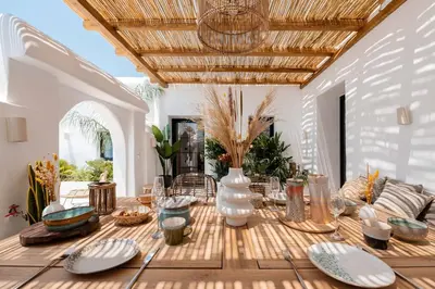 a dining room with a wooden table with plates on it at CasaCarma II, private pool, boho design, tradition in Lachania