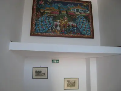 a painting on the ceiling of a room with two pictures at Eleftheria Lindian Studios I in Líndos