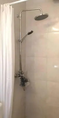 a shower in a bathroom with a shower curtain at The Olive Tree Villa Lindos in Líndos
