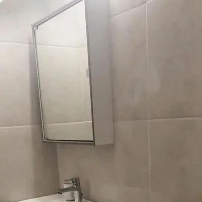 a bathroom with a mirror and a sink at The Olive Tree Villa Lindos in Líndos