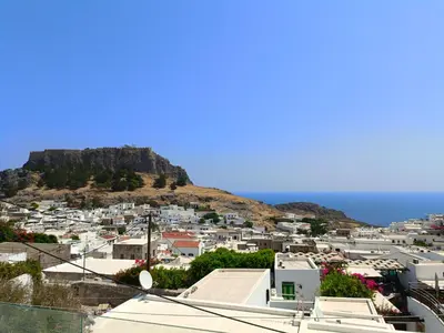 a view of a city with a mountain in the background at Lindos Villa Euphoria in Líndos